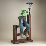 DUDE ON FENCE WITH SOLAR LAMP